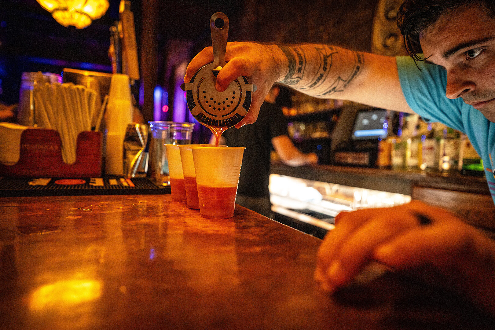 Bartender pouring cocktails