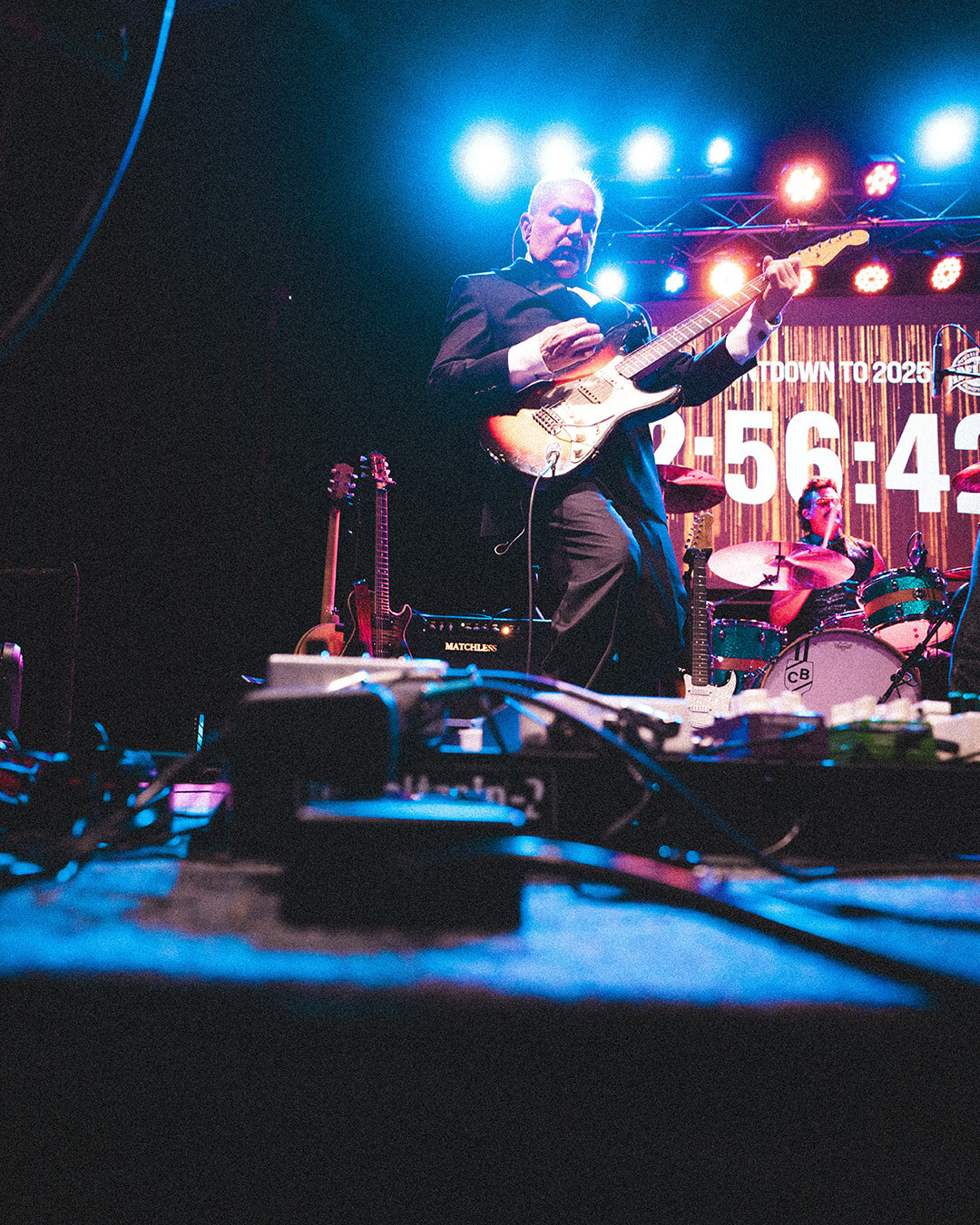 Fan watching guitarist perform at The Adelphia